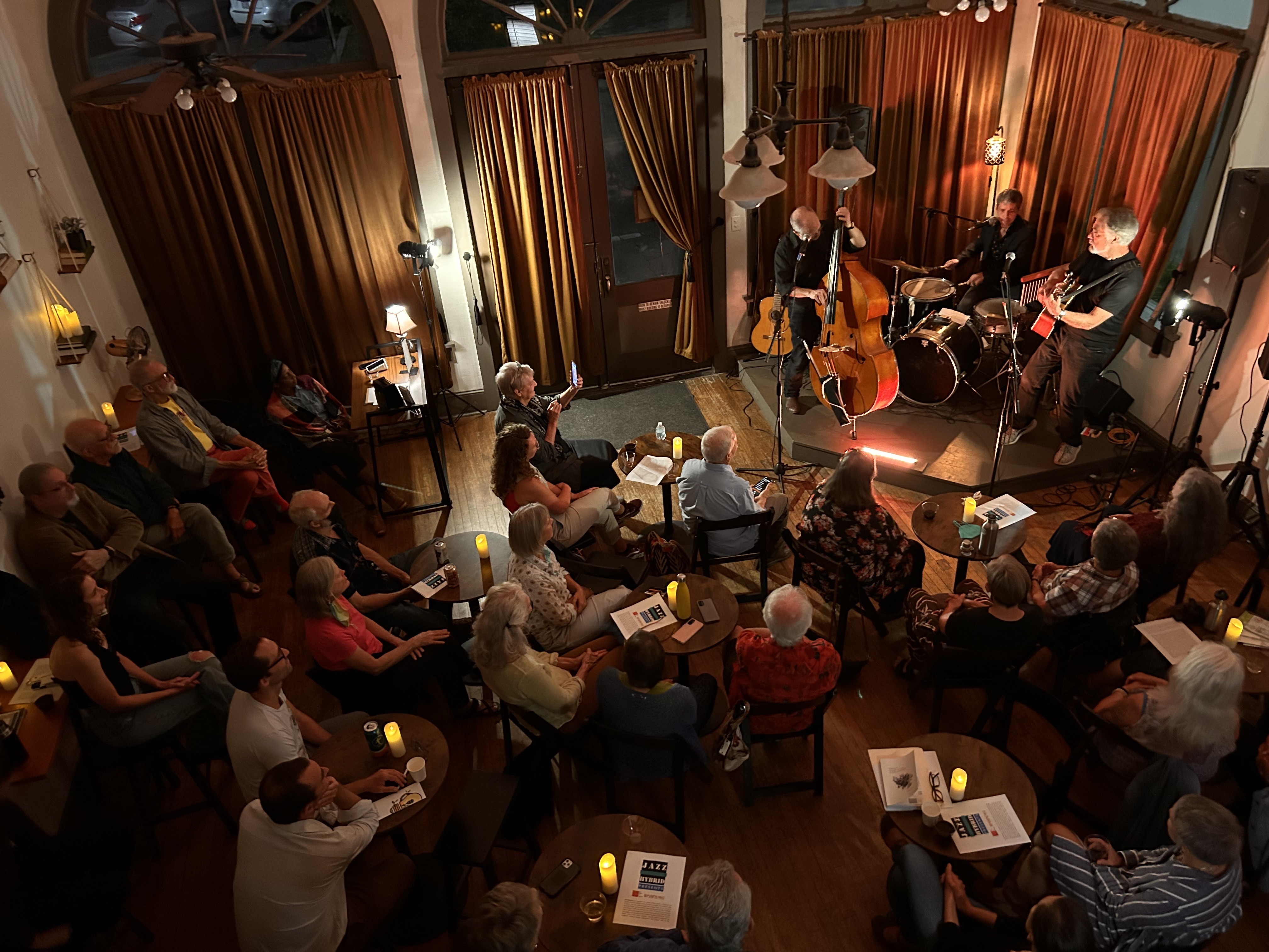 An audience listens to live music at storyparlor