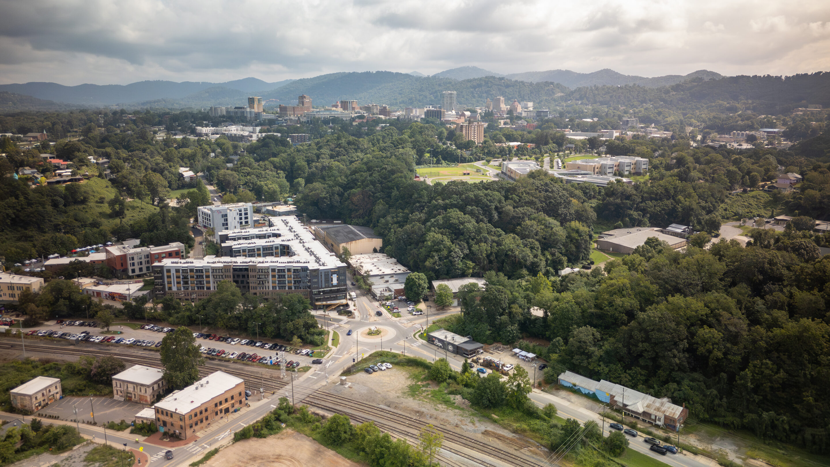 A family of three strolls through a downtown street in Western North Carolina